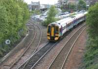 Southbound from Inverkeithing station in May 2005 passing Inverkeithing South Junction and the line down to Rosyth Dockyard. The train will shortly cross Jamestown Viaduct while the branch line will pass below it on its way to the dockyard.<br><br>[John Furnevel 11/05/2005]