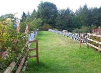 The viaduct over the Lyne Water approaching Lyne station from the east in September 2002. The former station is now a private house located beyond the trees.<br><br>[John Furnevel 19/09/2002]