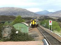 ScotRail 156474 forming a Mallaig - Glasgow Queen Street train about to enter Rannoch station on 20 May 2003 past the stone carving of former West Highland Railway director James Renton. Part of the 284 ft Rannoch Viaduct can be seen in the left background.<br><br>[John Furnevel 20/05/2003]