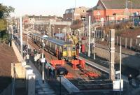 <I>'Well it definitely says platform 1 on the screen...'</I> Arrival from Dalmuir at Larkhall platform 2 on a sunny 12 December 2005, first day of the new service. Still a few teething problems with the platform information display.<br><br>[John Furnevel 12/12/2005]