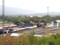 K1 2-6-0 62005 stands alone in the rain at Fort William MPD on A grey 29 September 2005. View is north east, with Lochaber High School in the centre background. The Mallaig line can be seen curving away to the left beyond the shed yard. <br><br>[John Furnevel 29/09/2005]