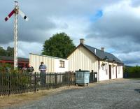 Rain clouds over Broomhill in September 2004 with a train for Aviemore in the station.<br><br>[John Furnevel 14/09/2004]
