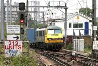 A Trafford Park - Felixstowe container train arrives at Camden Road Junction on 21 July 2005 behind Freightliner 90016. The train is coming off the direct freight-only link from the WCML at Primrose Hill Tunnel [see image 53461] as opposed to the 'branch' via Gospel Oak used by class 313 units operating the NLL passenger services at that time.<br><br>[John Furnevel 21/07/2005]