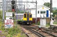 One of the Silverlink Class 313 units approaches Camden Road on a Richmond - Stratford service in July 2005. The train is coming off the 'branch' from Willesden Junction High Level via Gospel Oak. Camden Road was one of four traction current changeover points for 313 units on the North London Line at that time. For a close up of the sign [see image 5083].<br><br>[John Furnevel 21/07/2005]