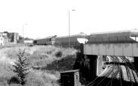 <I>The shape of things to come...!</I> One of the first of the privately owned Foster Yeoman class 59 locomotives has just crossed the WCML with its aggregates train at Willesden Junction in May 1986. The freight is on the link from Acton Wells to Kensal Green Junctions taking it from the West London to the North London line. [See image 23123]<br><br>[John Furnevel 04/05/1986]