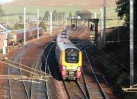 An up Virgin Voyager runs south past a Royal Mail class 325 stabled in the sidings at Abington on 24 December 2005.<br><br>[John Furnevel 24/12/2005]