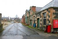 Remains of track running into March Street Mills, Peebles, in December 2005. View is north towards George Street, with the route of the old main line off to the right on the other side of the buildings.<br><br>[John Furnevel 02/12/2005]