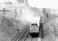 On a cold and frosty morning in December 1972 the Edinburgh Waverley portion off a down Liverpool/Manchester - Glasgow/Edinburgh service heads north from Carstairs East Junction past the old east wing of the State Hospital.<br><br>[John Furnevel 19/12/1972]