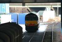 Locomotive and freight stand in the shadows in one of the sheds at WHM, Grangemouth in January 2006. The windows of Fouldubs Junction signal box can just be seen between the M9 motorway supports.<br><br>[John Furnevel 24/01/2006]