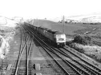 The Rootes/Chrysler company train, hauled by a pair of Brush Type 4s, photographed on the southern approach to New Cumnock heading for Linwood in 1973.<br><br>[John Furnevel 21/06/1973]