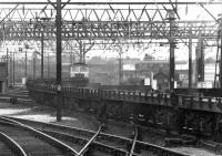 A Brush type 4 with a trainload of empty flats runs north from Crewe in 1970.<br><br>[John Furnevel 30/06/1970]