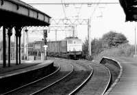 Looking north west from Peniston towards Manchester in September 1978 as a class 76 approaches the station with a trans-Pennine freight off the Woodhead route.<br><br>[John Furnevel 12/09/1978]