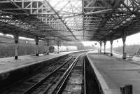 Looking out along the deserted west facing bay platforms at Dundee in January 1992 as a 158 pulls away from platform 1 on a service to Edinburgh.<br><br>[John Furnevel 24/01/1992]