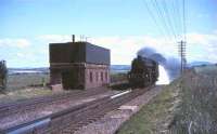 Trackside photography in close proximity to watertroughs required judgement and agility - for reasons well illustrated in this shot of Black 5 45360 approaching at speed on Strawfrank Troughs with scoop down and tender overflowing. The date is 17 July 1965 and the train is a Crewe - Aberdeen relief... (and the answer is <I>yes, but it could have been a lot worse..</I>)<br><br>[John Robin 17/07/1965]