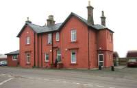 The refurbished station building at Thornhill in January 2006, with northbound coal empties passing.<br><br>[John Furnevel /01/2006]