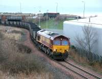 On a cold February morning in 2006, with mist hanging over the Forth, EWS 66028 brings a trainload of imported coal from Leith Docks below Seafield Road and enters the site of the former Meadows Yard. The coal is part of a major consignment from Russia destined for Cockenzie power station.<br><br>[John Furnevel 07/02/2006]