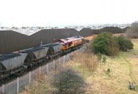 EWS 66028 passing through the former Meadows Yard eastbound in February 2006 with imported coal from Leith Docks heading for Cockenzie power station. The old yard is now a combination of large retail warehouses and an attractive local neighbourhood nature area [see image 3191].<br><br>[John Furnevel 07/02/2006]