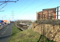 View north in 2002 from the remains of the bridge that once carried the Lothian Lines over the <I>Sub</I>. Brunstane station is under construction in the background. The view would once have been blocked by Niddrie North signal box [see image 32080]. <br><br>[John Furnevel 11/02/2002]