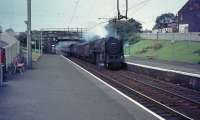 70003 hurries through Uddingston Station bound for Glasgow.<br><br>[John Robin 19/07/1964]