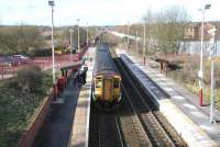 An Edinburgh Waverley - Glasgow Central via Shotts train calls at Carfin in February 2006. View west towards Holytown Junction from the B7066 road bridge.<br><br>[John Furnevel 13/02/2006]