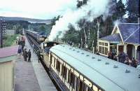 Jones Goods waits for the late running Edinburgh train to cross at Carrbridge in 1965.<br><br>[John Robin 21/08/1965]