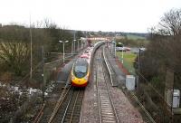 The 10.10 Virgin Trains Edinburgh Waverley - London Euston Pendolino westbound through Curriehill on 7 March 2006. This is the second station to stand on this site, having been officially opened in 1987.<br><br>[John Furnevel 07/03/2006]