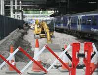 Work well underway on extending platform 12 at Waverley, seen here on 13 July 2017 from the position previously occupied by the buffer stops. (Photographed through a gap in the safety barrier). Demolition of the platform buildings directly behind the camera position is due to commence shortly. [See image 59986]<br><br>[John Furnevel 13/07/2017]