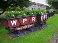 Mocked-up mine tubs painted to recall the Wemyss Private Railway, located where the Wemyss & Buckhaven (Thornton Junction - Methil) line passed under the A955. Beyond are a couple of salvaged mine cars. 9th July 2017.<br><br>[Bill Roberton 09/07/2017]