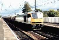 A cement train runs west through Slateford station on a bright summer afternoon in August 1994 hauled by BR Coal Sector liveried class 60 no 60074. The locomotive is carrying the name <I>Braeriach</I>.<br><br>[John Furnevel 02/08/1994]