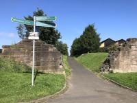Sustrans' subtle alterations to the abutment of the former Smith Street bridge at the west end of Whiteinch Riverside station, now the start of the Lanarkshire and Dumbartonshire Railway section of National Cycle Network Route 7.<br><br>[Colin McDonald 12/07/2017]