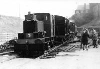 Early days on the East Lancashire Railway at the newly established Bury Transport Museum in Castlecroft Goods shed. The Planet 4wDM seen here on temporary track at an Open Day was the first locomotive acquired by the ELRPS. Together with the LYR van, Midland Rly hand crane and the RSH 0-6-0T the Planet had recently been moved from the initial preservation site at Helmshore. The elderly gentleman on the right, wearing his trademark Plus 4s, is Donald Heyworth who preserved a number of commercial road vehicles and other local artefacts and was active in the ELR at this time. <br><br>[Mark Bartlett //1972]