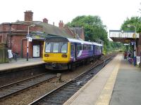 Pacer 142058, working from Rose Hill to Piccadilly, calls at the first stop at Romiley on 16th June 2017. From here it will take the right hand route via Guide Bridge where another Rose Hill bound train can be seen approaching. Trains from New Mills and Marple take the left hand route from here to run via Reddish North.  <br><br>[Mark Bartlett 16/06/2017]