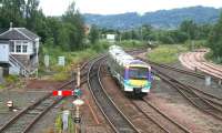 An Edinburgh bound train passing Stirling North signal box in July 2007 on the approach to the station. ScotRail 170407 is still carrying its old National Express livery. Over on the right work is in progress on the Alloa line, which would reopen to passengers in May the following year.<br><br>[John Furnevel 24/07/2007]