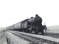 Recently laid ballast in place along the section to the east of Carntyne on 28 April 1958, as Parkhead V3 67613 pulls away from the station and runs slowly past the PW team with a Hyndland - Easterhouse train.  <br><br>[G H Robin collection by courtesy of the Mitchell Library, Glasgow 28/04/1958]