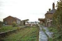 The Wymondham to Kings Lynn line was not earmarked for closure in the Beeching report, but was a casualty of the 1960s none the less. Once the Dereham - Wells and Swaffham - Thetford branches had been pruned from it in 1964 and “rationalization” applied, it faded away. This photo is of the intermediate Swaffham station (former junction for Thetford) on 23rd October 1976, some 8 years after final closure. The view is eastward. [Ref query 1663]<br><br>[Mark Dufton 23/10/1976]