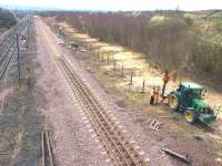 Only 9 weeks to go before the commencement of train services from the under construction Newcraighall station behind the camera. With the new reversing siding recently installed, work is now being carried out on the associated security fencing. [See image 10140].<br><br>[John Furnevel 01/04/2002]