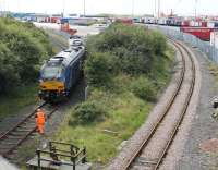 On possibly its first revenue earning working a very clean DRS 68031, and class mate 68024 <I>Centaur</I>, has just arrived light engine at Heysham to collect a flask load for Sellafield. The guard has locked the train in to the power station siding and is making his way back to the rear loco. [See image 37885] for the same location but different motive power five years earlier.   <br><br>[Mark Bartlett 09/08/2017]