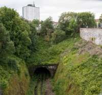 Reverting to nature - overgrown and with a waterfall - the entry to the Ann Street tunnel for Greenock Princes Pier at Mearns Street Junction. View looks west.<br><br>[Ewan Crawford 03/08/2017]