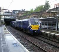 An Edinburgh service enters High Street on 5 August. The view looks west to Queen Street.<br><br>[David Panton 05/08/2017]