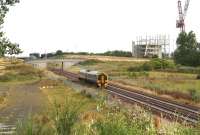 The ScotRail 0828 ex-Tweedbank pulls away from the Shawfair stop and heads for Newcraighall on 3 August 2017. It will soon pass the Biogen food waste recycling plant over on the left beyond the bridge, built on the north west corner of the old Millerhill marshalling yard. Meantime, taking shape on the right of the picture, is the new Edinburgh and Midlothian Recycling and Energy Recovery Centre, under construction on another part of the former yard further to the south. This will replace the current refuse handling depot at Powderhall. Good to see what's left of the old yard isn't going to waste!  <br><br>[John Furnevel 03/08/2017]