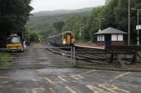 0730 at Garelochhead and Scotrail Sprinter 156500 leads the 0521 from Oban to Glasgow into the station. In the yard a <I>Road-Rail</I> maintenance truck sits alongside the engineers siding.<br><br>[Mark Bartlett 01/08/2017]