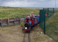 Steam outline 2-8-0 <I>Harry's Dream</I> leans into a curve at the St Annes Miniature Railway, which encircles a pitch and putt course on the promenade. The tender is considerably bigger than the locomotive as it houses the diesel engine and the driving seat and controls. Duties on the railway are shared between this loco and a Western outline diesel. [See image 50977].<br><br>[Mark Bartlett 08/08/2017]