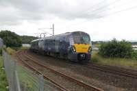 A tree stump on the Waitrose service road is excellently placed to give a better view over the lineside fence at Craigendoran Junction. 334004 leads a six car set from Edinburgh taking the branch to Helensburgh Central on 30th July 2017. <br><br>[Mark Bartlett 30/07/2017]