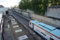 When I last photographed from Trinity Street road bridge along platform 5 at Bolton in mid July, the track had still to be replaced. On 09 August 2017 however not only has the track appeared but a track tamping machine was working it's way along. Further evidence of the progress being made on this station improvement project.<br><br>[John McIntyre 09/08/2017]