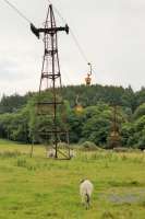 Looking towards Claughton Moor from the A683 road in August 2017, with a succession of clay buckets on the move to and from the brick works behind the camera. Note the four wheels on the loaded side of the pylon whereas only two are required to support the returning empties. <br><br>[Mark Bartlett 11/08/2017]