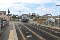 Most of the Blackpool Tramway runs alongside (or along) the road but the stretch between the Rossall School and Heathfield Road stops is on an independent alignment. <I>Flexity</I> 009, heading for Fleetwood, runs between the houses and across South Strand level crossing as it approaches the stop at Rossall Square on 12th August 2017. <br><br>[Mark Bartlett 12/08/2017]