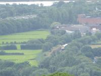 An Arriva Class 175/0 heads away from Llandudno Junction on a service for Chester and Manchester on 27th July 2017. This image was taken from the grounds of the Welsh Mountain Zoo near Colwyn Bay and behind the train the A55 road can be seen dropping down towards the Conwy Estuary, which it tunnels under. <br><br>[Mark Bartlett 27/07/2017]