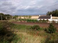 Remains of the long-closed halt at Seton Mains are as scanty as information about it. The one picture on line has a train in the way! However at least some of it was in this picture. Seton level crossing was just to the east (right) but the road it served is no longer there. The contiguous villages of Cockenzie and Port Seton are a mile away, so maybe not too many residents used the station.<br>
<br><br>[David Panton 16/08/2017]