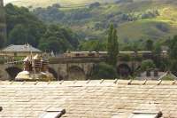 Crossing the viaduct above the rooftops of Todmorden, GBRF 66716 heads east with a loaded biomass train from Liverpool Biomass Terminal on 17 August 2017. The train was heading to Drax power station.<br><br>[John McIntyre 17/08/2017]