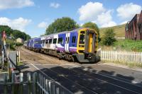 A Northern Blackpool to York service passes over the level crossing at the site of Portsmouth station (closed 1958) on the Copy Pit line between Gannow and Hall Royd Junctions.<br><br>[John McIntyre 17/08/2017]